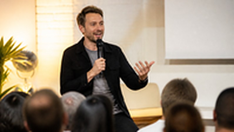 A speaker on stage talking without notes